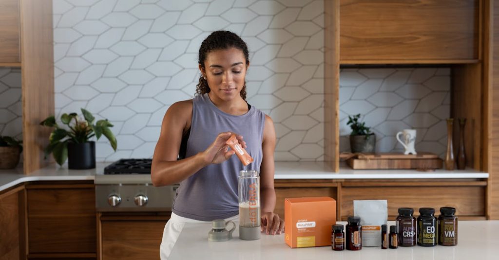 pexels-photo-15837848-15837848 A woman uses essential oils and supplements in a contemporary kitchen for wellness.