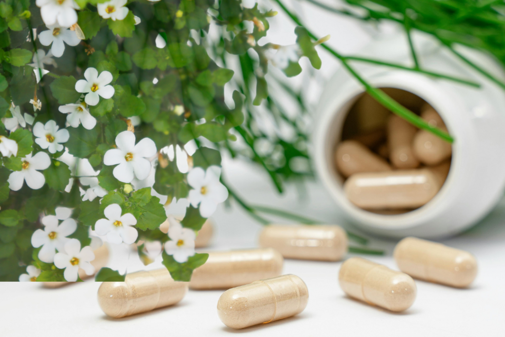 a group of supplement pills next to a plant-supplement for energy and focus